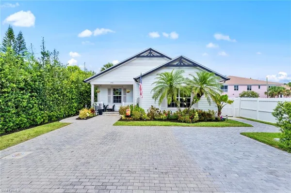 a view of a house with a yard and flower plants