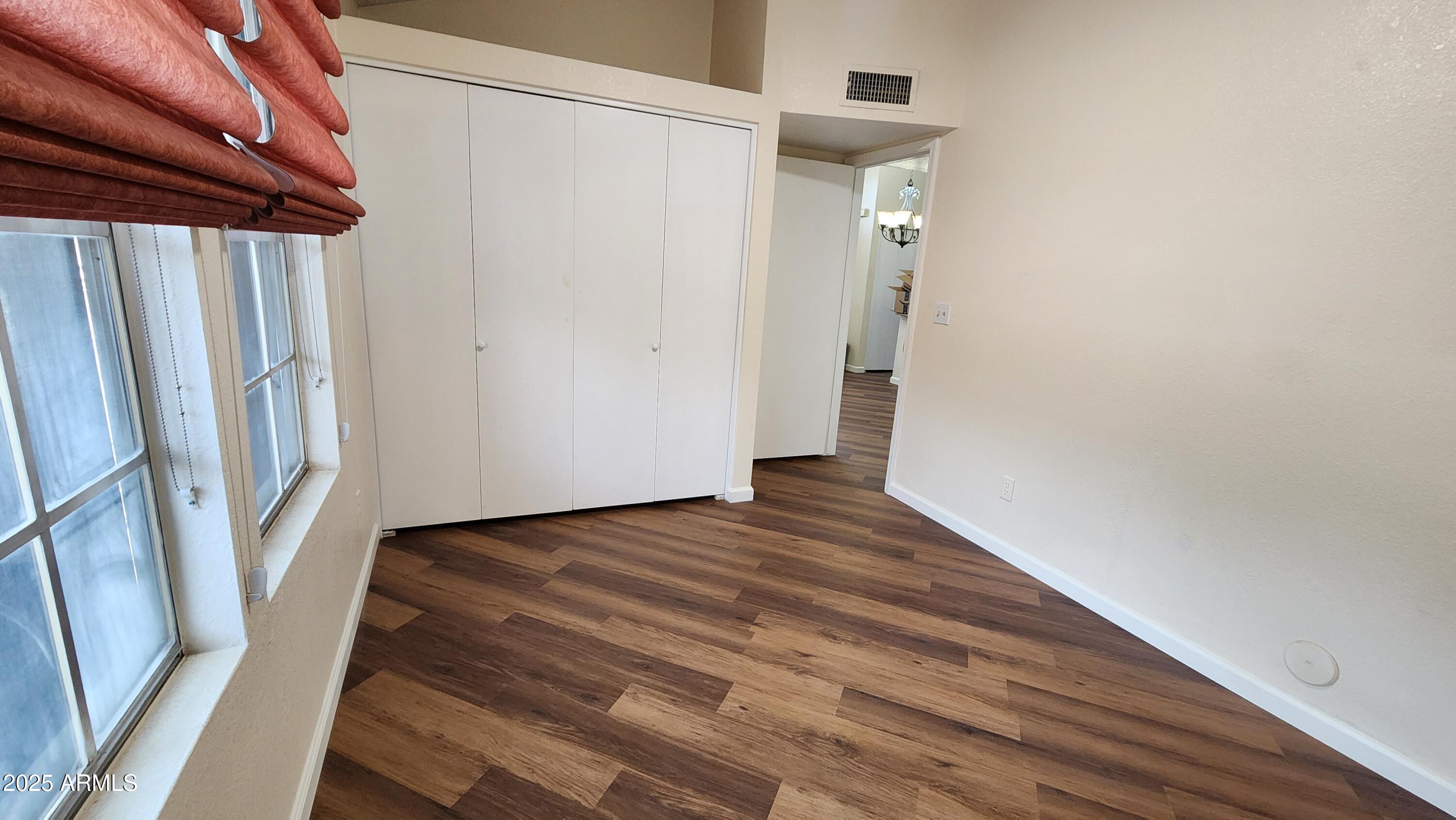 7977 West Wacker Road, Unit 226 Peoria, AZ 85381 - Photo 11 of 19 a view of a room with wooden floor and stairs