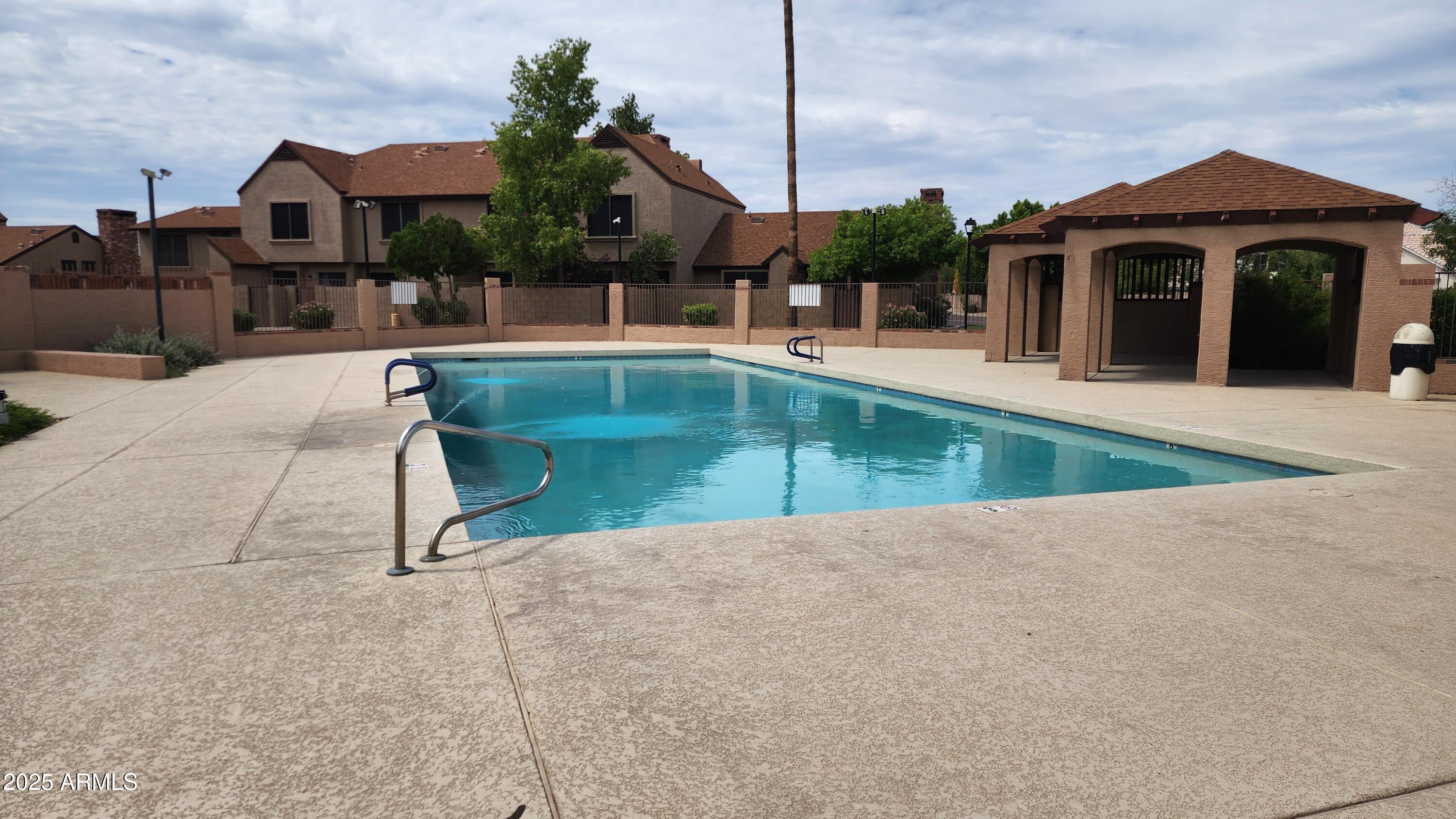 7977 West Wacker Road, Unit 226 Peoria, AZ 85381 - Photo 18 of 19 a view of a house with a swimming pool