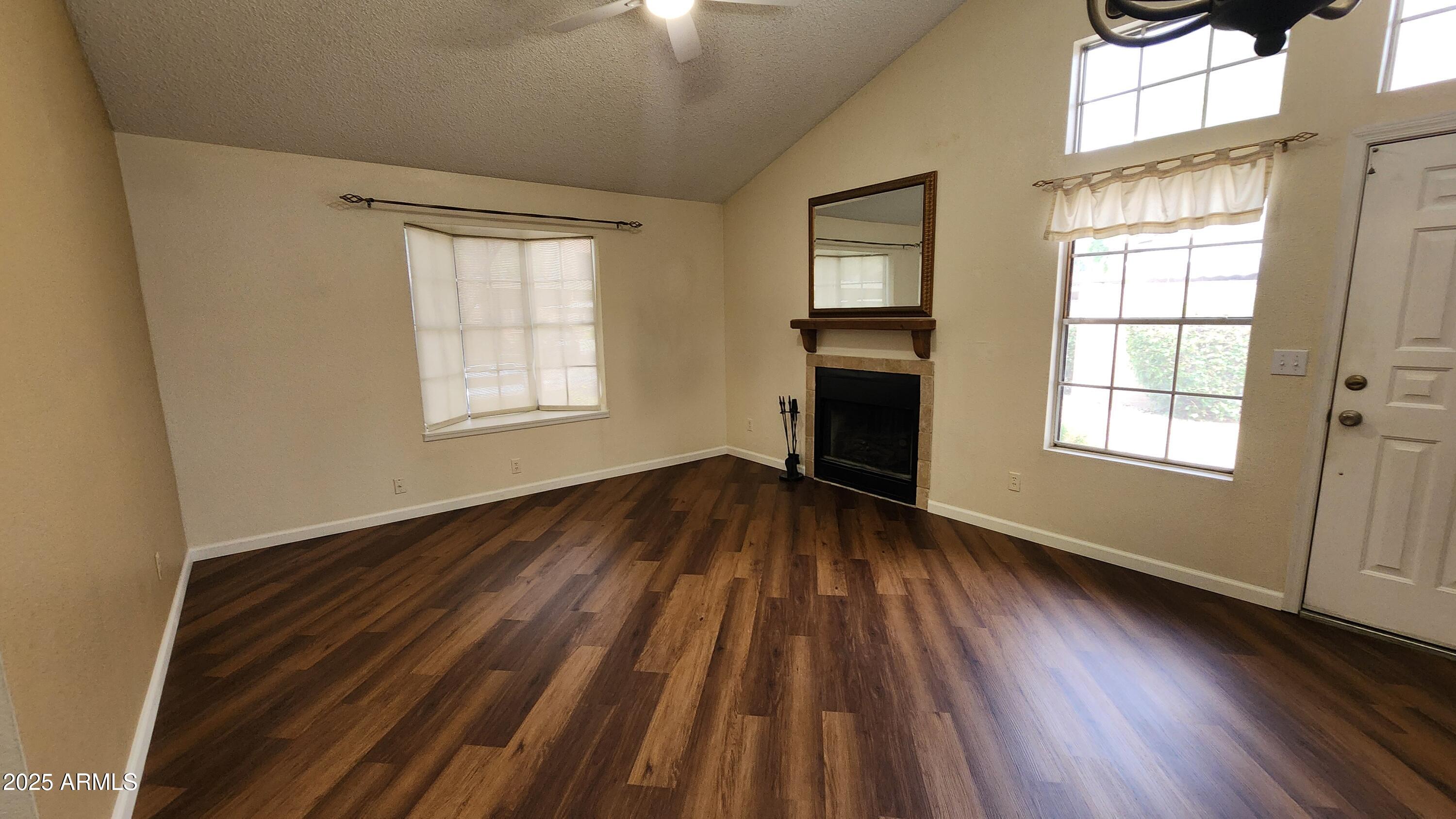 7977 West Wacker Road, Unit 226 Peoria, AZ 85381 - Photo 2 of 19 an empty room with wooden floor and windows