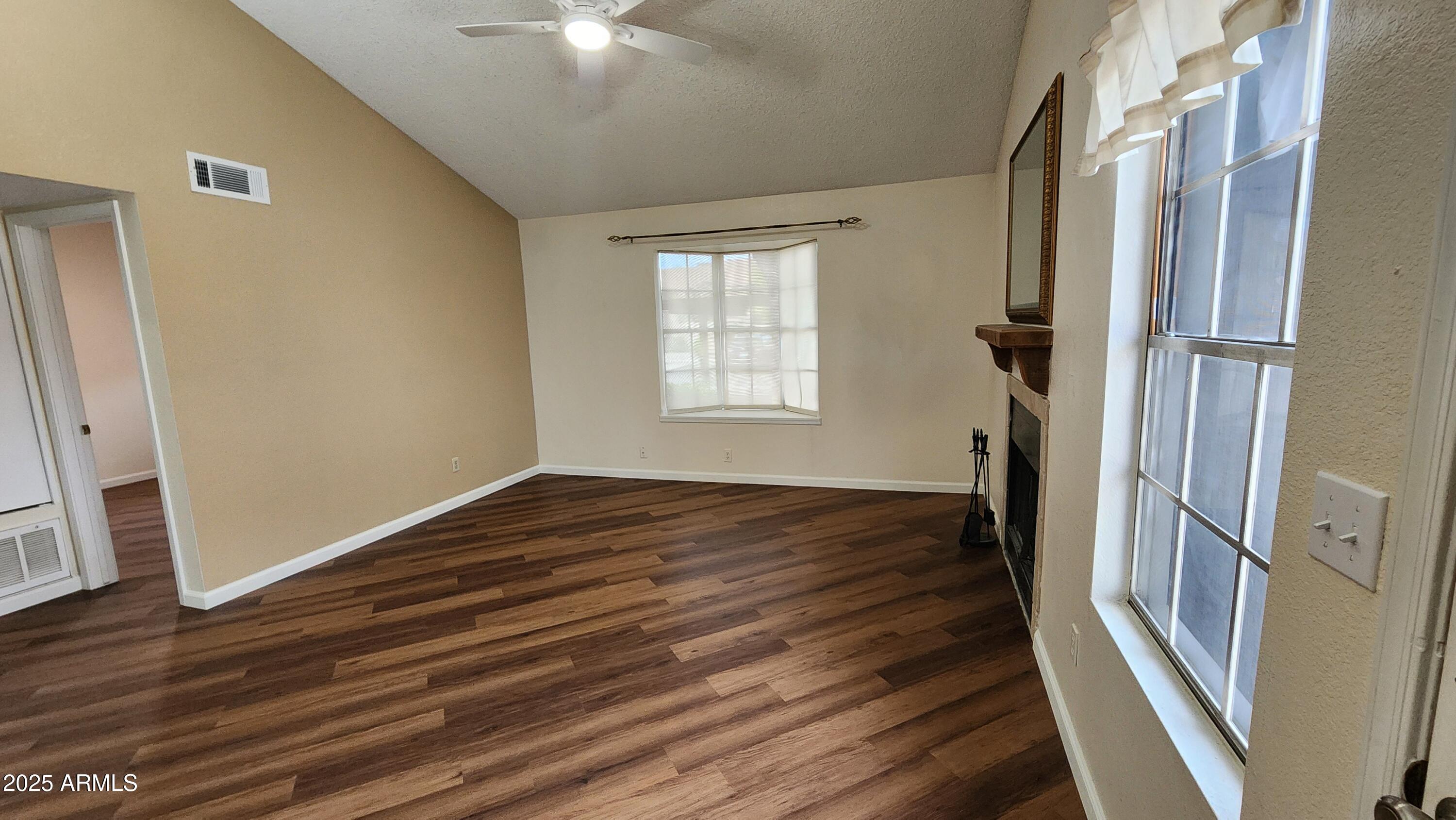 7977 West Wacker Road, Unit 226 Peoria, AZ 85381 - Photo 6 of 19 a view of an empty room with wooden floor and a window