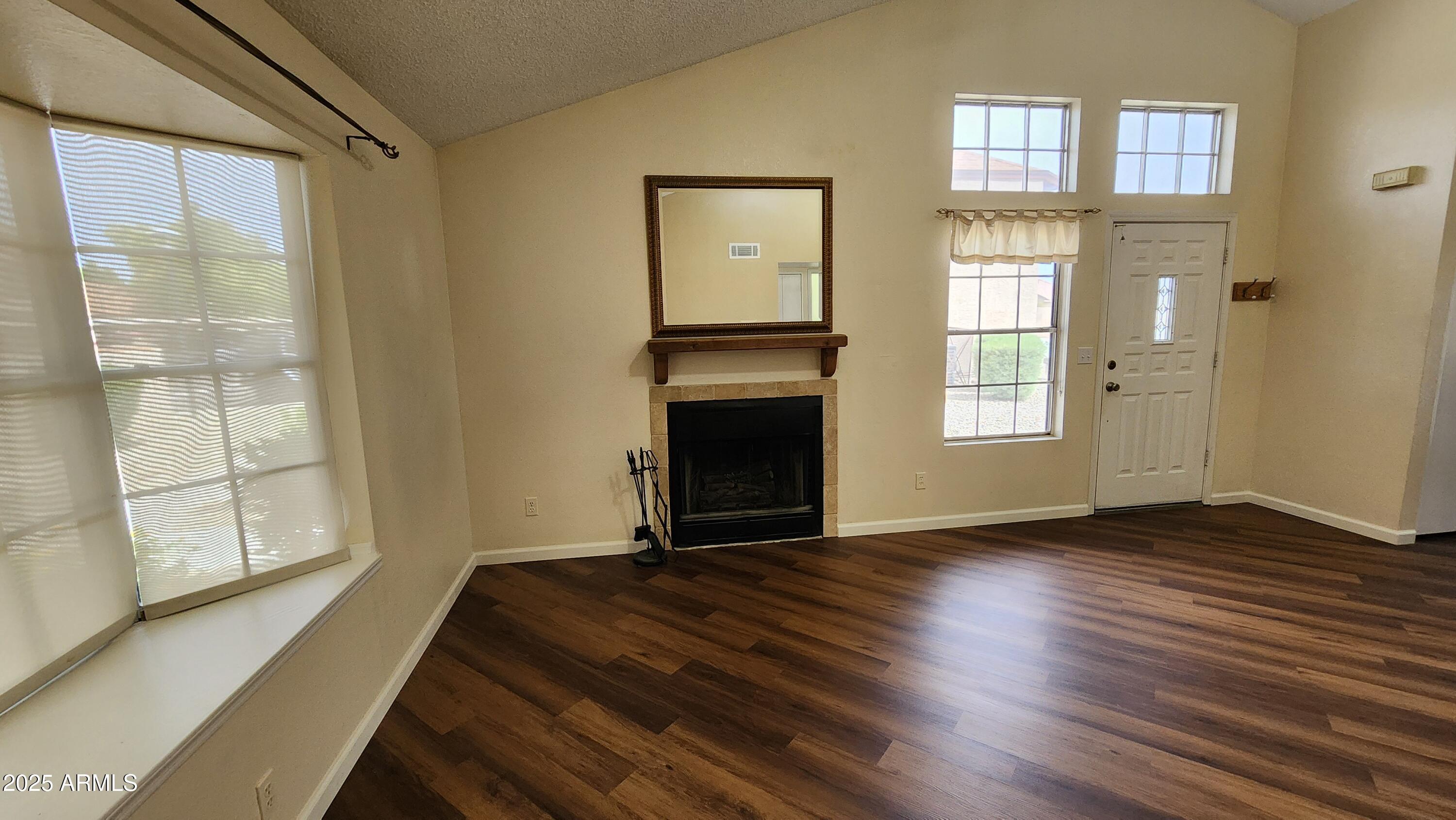 7977 West Wacker Road, Unit 226 Peoria, AZ 85381 - Photo 7 of 19 a view of an empty room with wooden floor and a window