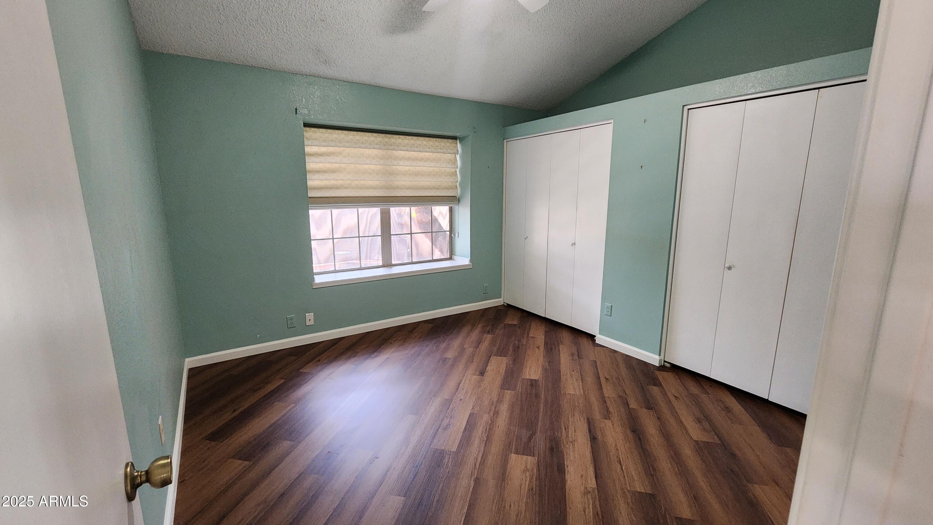 7977 West Wacker Road, Unit 226 Peoria, AZ 85381 - Photo 8 of 19 a view of an empty room with wooden floor and a window