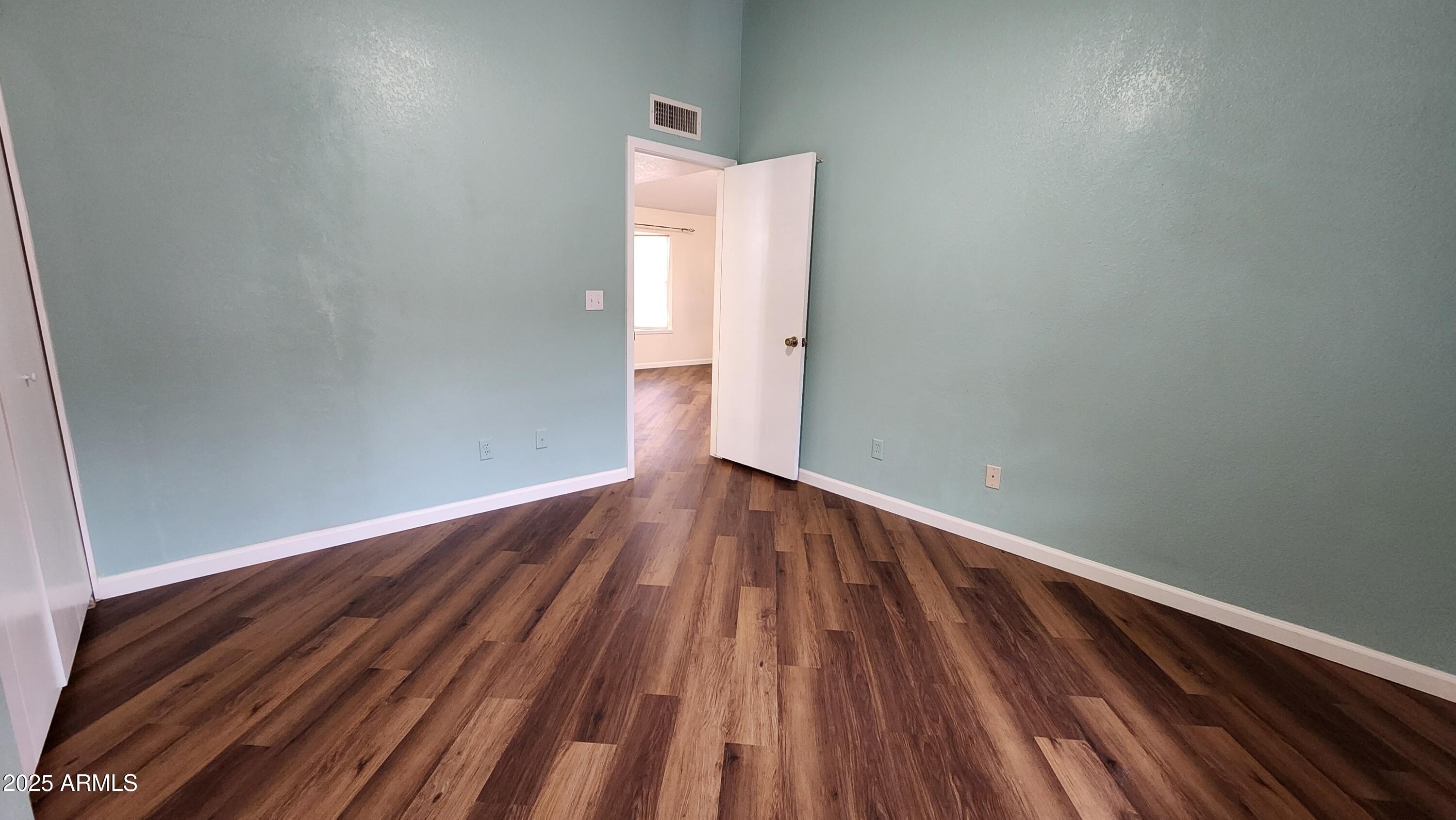 7977 West Wacker Road, Unit 226 Peoria, AZ 85381 - Photo 9 of 19 a view of room with wooden floor