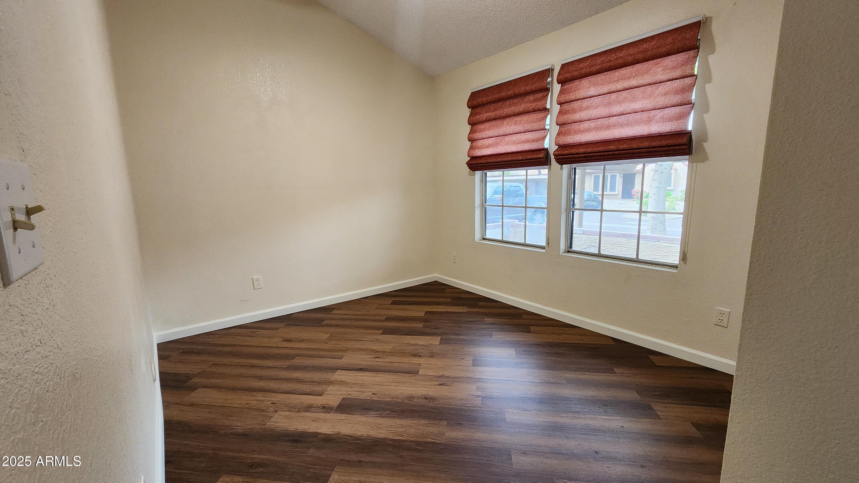 7977 West Wacker Road, Unit 226 Peoria, AZ 85381 - Photo 10 of 19 a view of empty room with wooden floor and fan