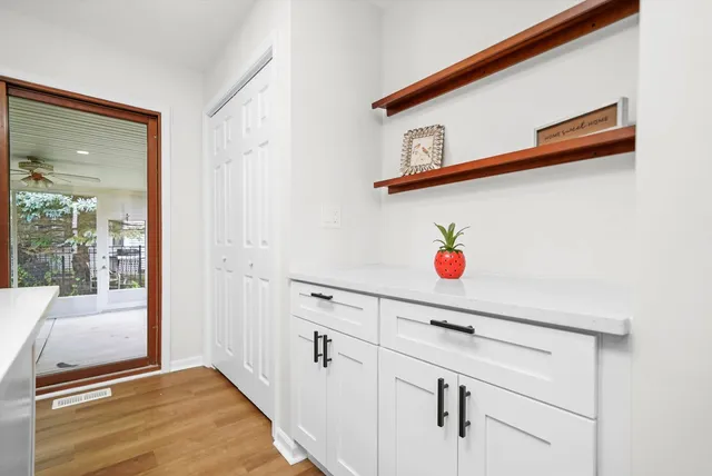 a bedroom with a bed and a painting on the wall