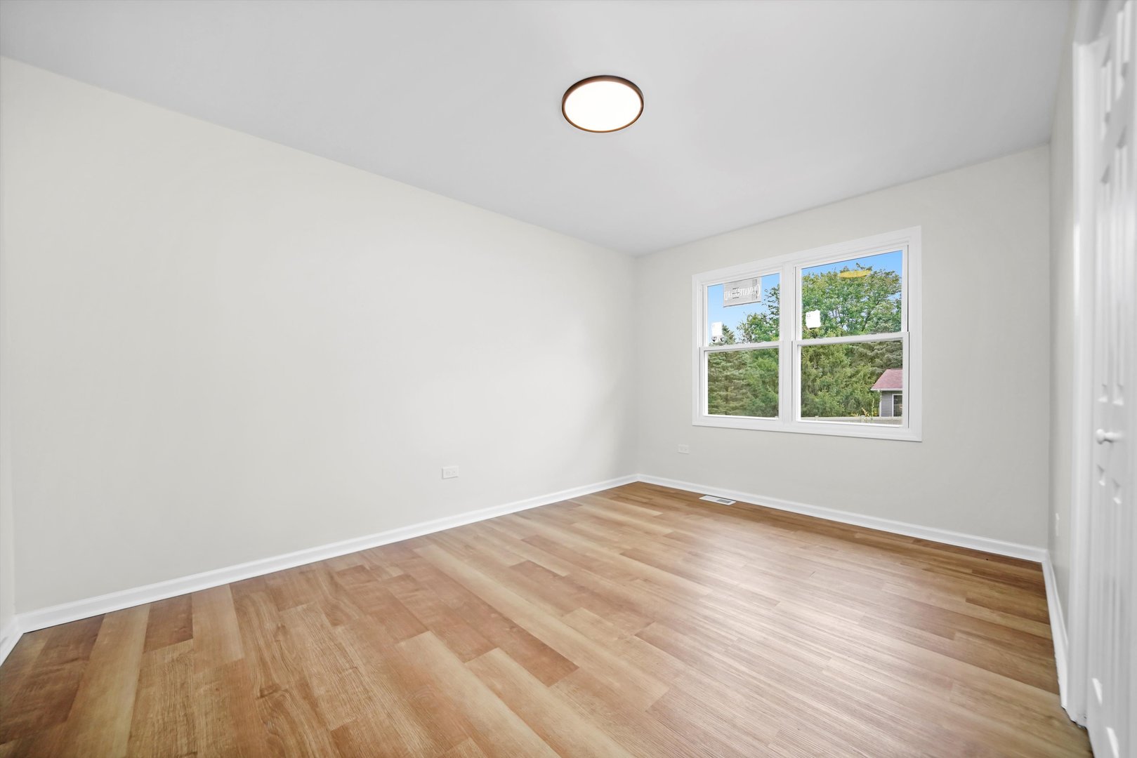 1668 Hidden Valley Drive Bolingbrook, IL 60490 - Photo 18 of 43 an empty room with wooden floor and windows