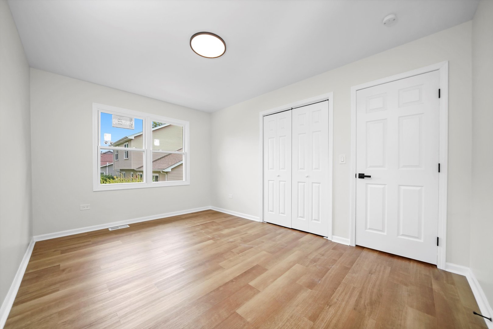 1668 Hidden Valley Drive Bolingbrook, IL 60490 - Photo 19 of 43 a view of an empty room with window and wooden floor