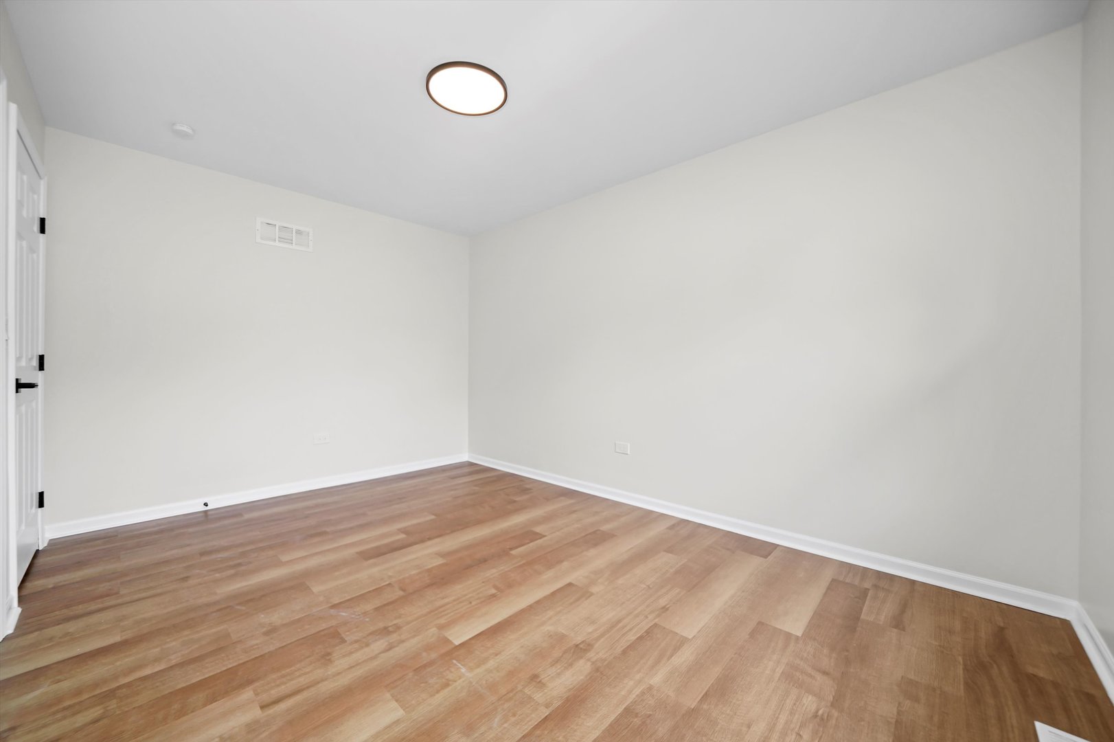 1668 Hidden Valley Drive Bolingbrook, IL 60490 - Photo 21 of 43 a view of an empty room with wooden floor