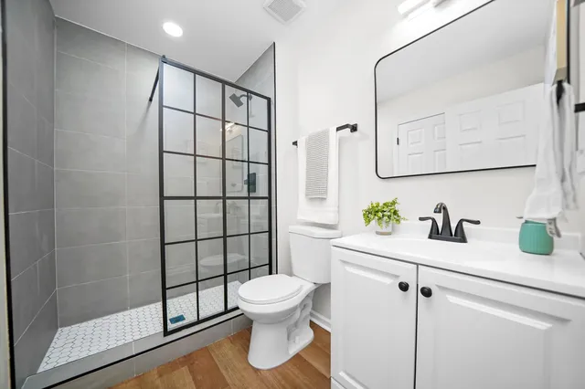 a white toilet sitting next to a bathroom sink