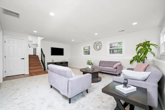 a living room with furniture and white walls