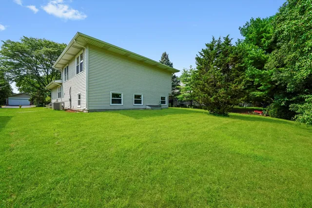 a view of a house with a backyard