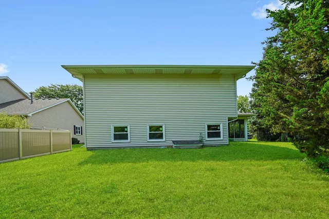 an aerial view of a house with garden space and street view