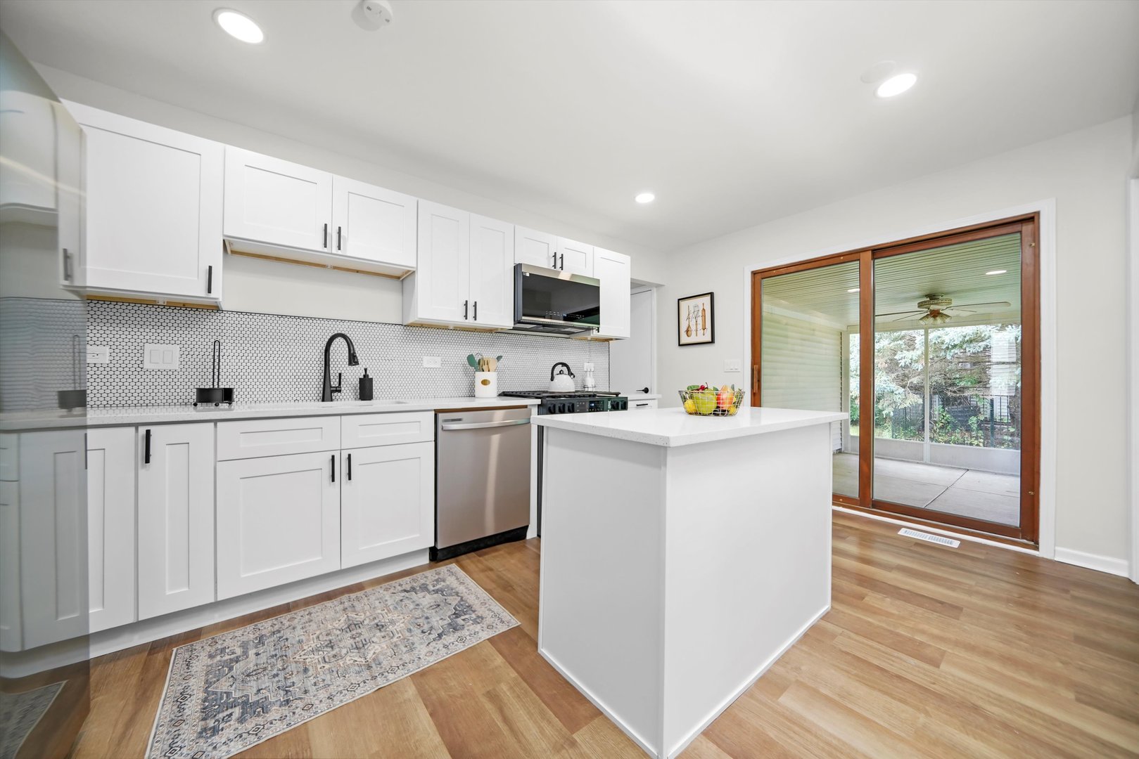 1668 Hidden Valley Drive Bolingbrook, IL 60490 - Photo 10 of 43 a kitchen with cabinets and wooden floor