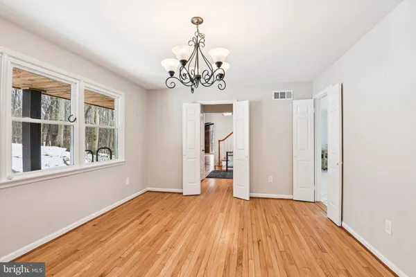 a view of a room with wooden floor and windows