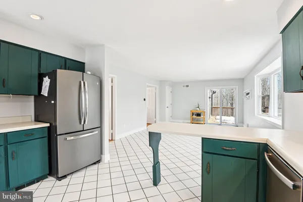 a kitchen with granite countertop a refrigerator and a sink