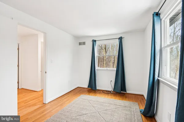 a view of room with window and hardwood floor