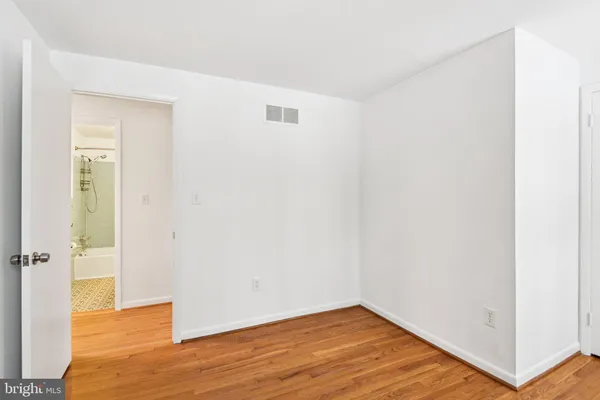 a view of a room with wooden floor