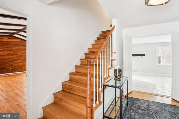 a view of entryway and hall with wooden floor