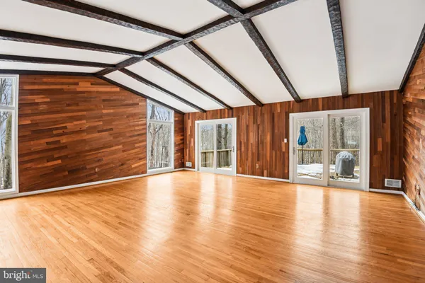 a view of an empty room with glass door