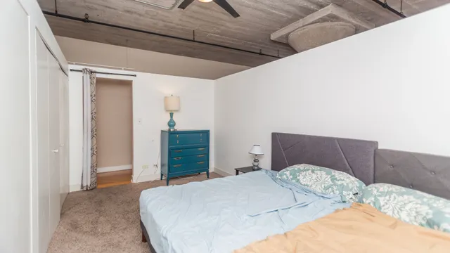 a bedroom with a bed and a dresser