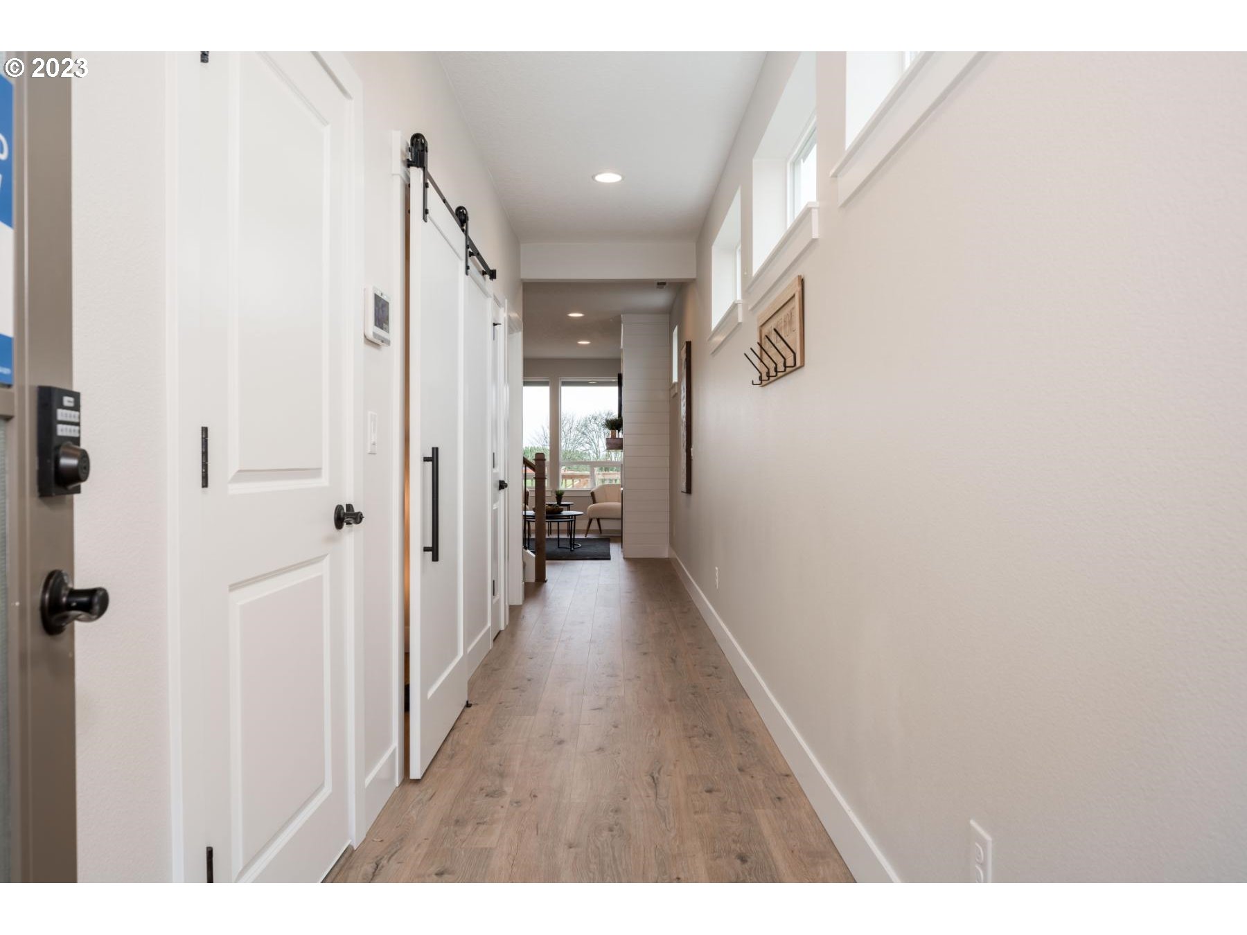 731 Northeast 174th Street Ridgefield, WA 98642 - Photo 3 of 27 a view of a hallway with wooden floor