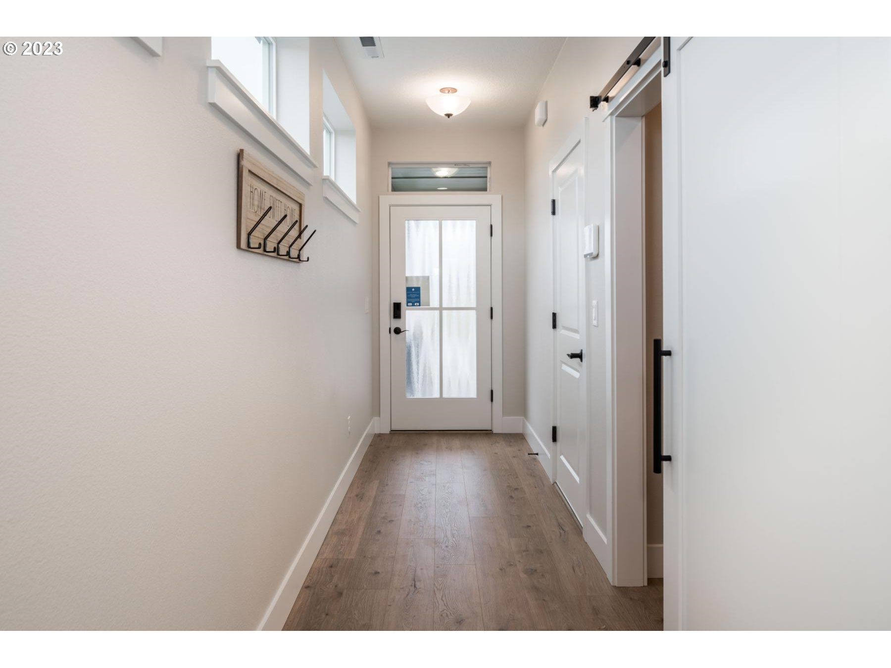 731 Northeast 174th Street Ridgefield, WA 98642 - Photo 4 of 27 a view of a hallway with wooden floor
