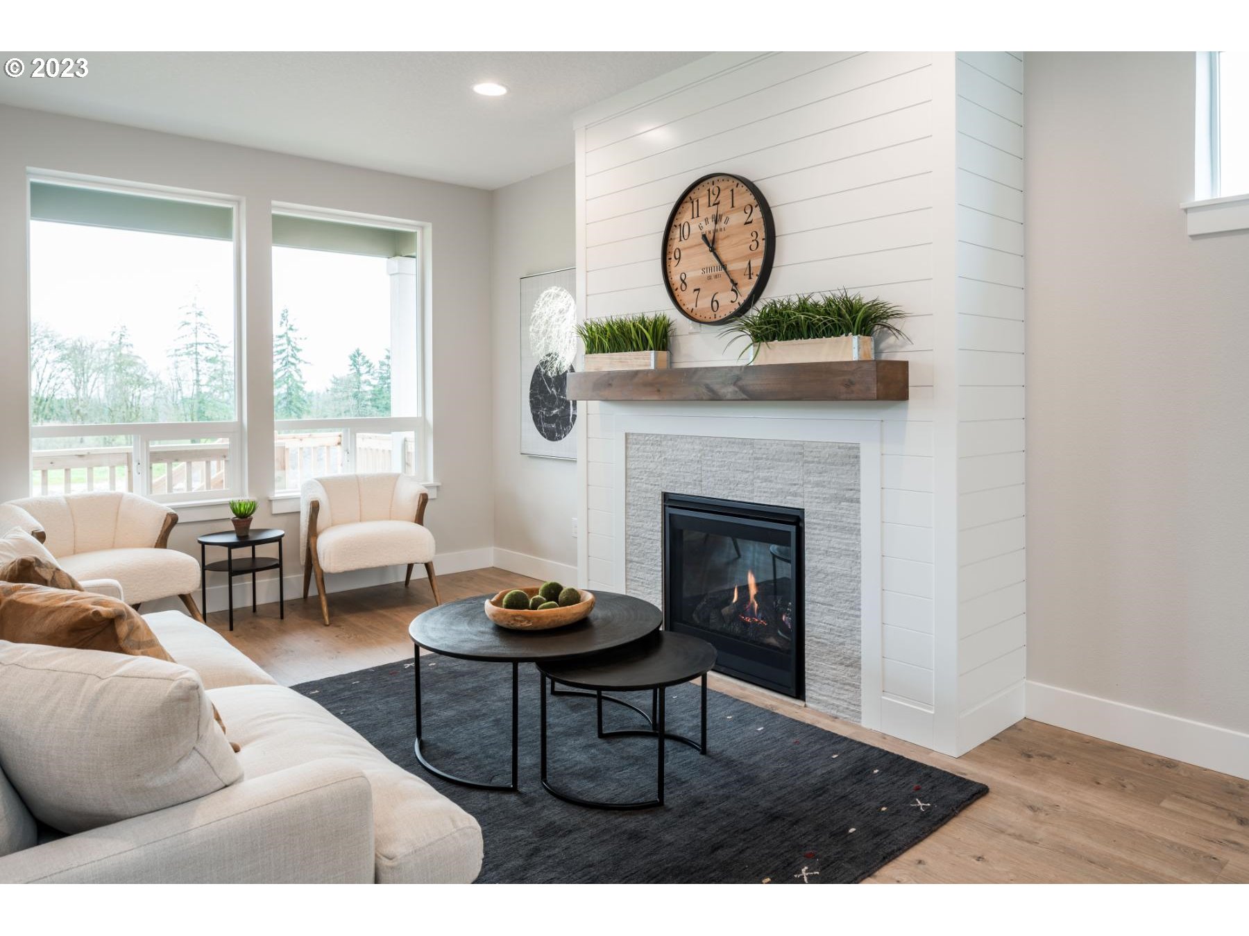 731 Northeast 174th Street Ridgefield, WA 98642 - Photo 9 of 27 a living room with furniture a fireplace and a large window