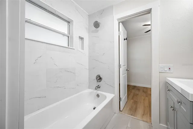 a bathroom with a bathtub and a sink