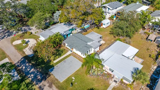an aerial view of a house with a yard and trees