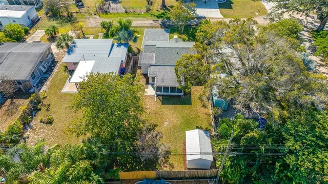 an aerial view of a house with a yard basket ball court and outdoor seating