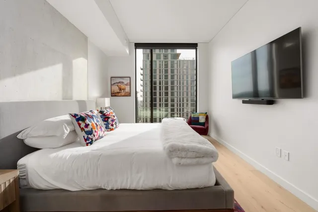 a bedroom with a bed and a flat screen tv