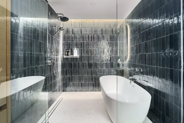 a bathroom with a bathtub and shower