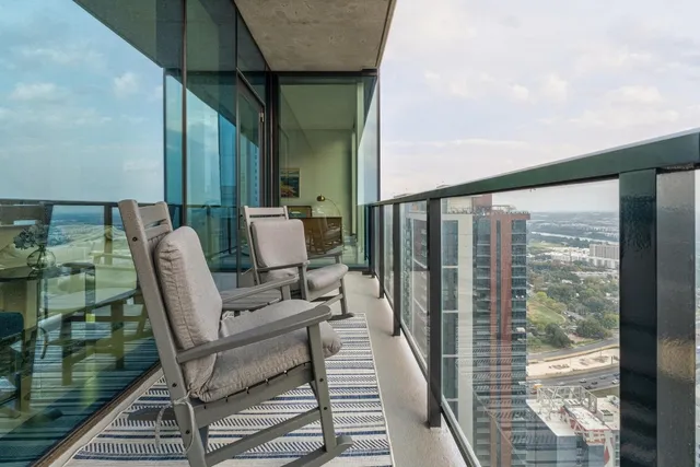 a balcony with chairs and outdoor view