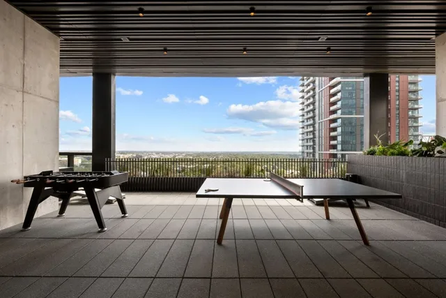 a view of a terrace with seating space and two windows