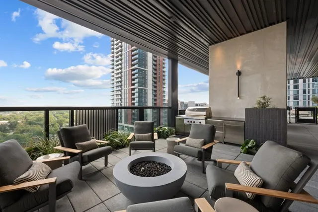 a living room with furniture and a floor to ceiling window