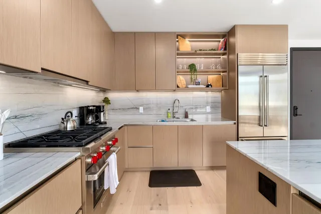a kitchen with stainless steel appliances a sink a stove and a refrigerator