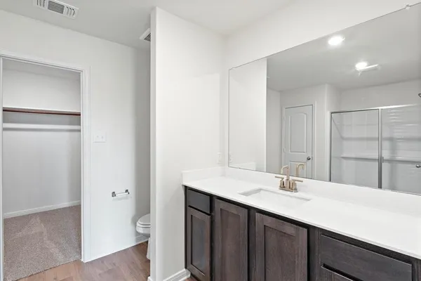 a bathroom with a sink double vanity and a toilet
