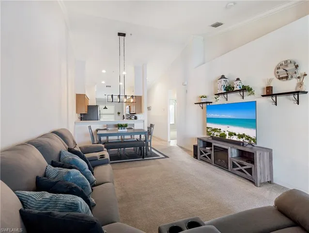 a living room with furniture a rug and a chandelier