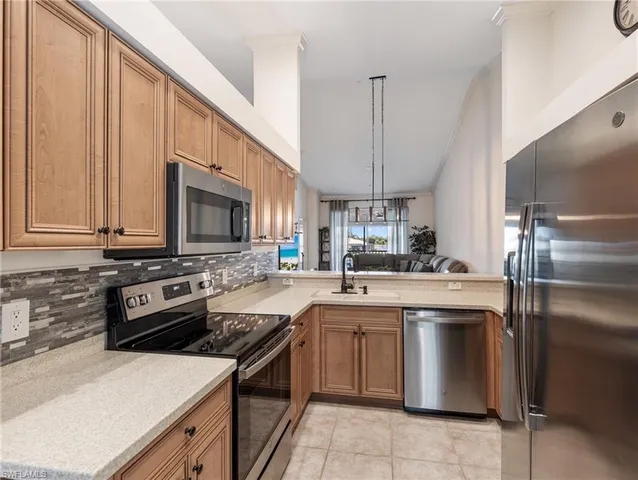 a kitchen with a sink stove and microwave