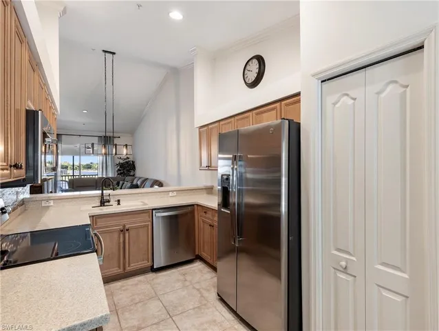 a kitchen with a sink stainless steel appliances and cabinets