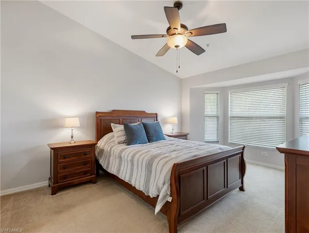 a bedroom with a bed a window and a chandelier