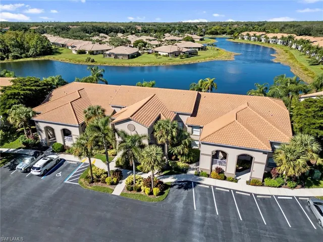 an aerial view of a house with garden space and lake view