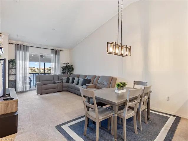 a living room with furniture and a dining table