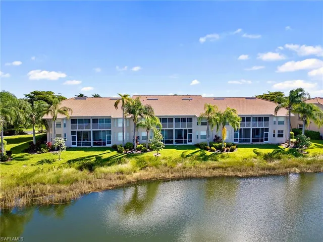 a view of a house with swimming pool and a yard
