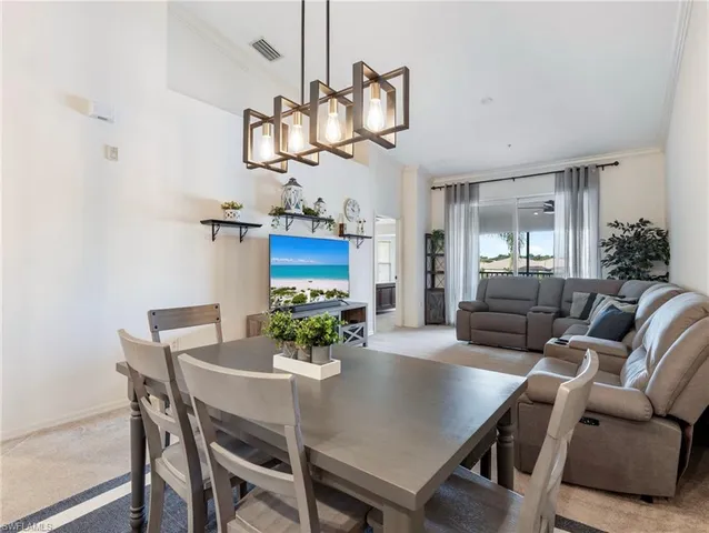 a view of a dining room with furniture and a chandelier