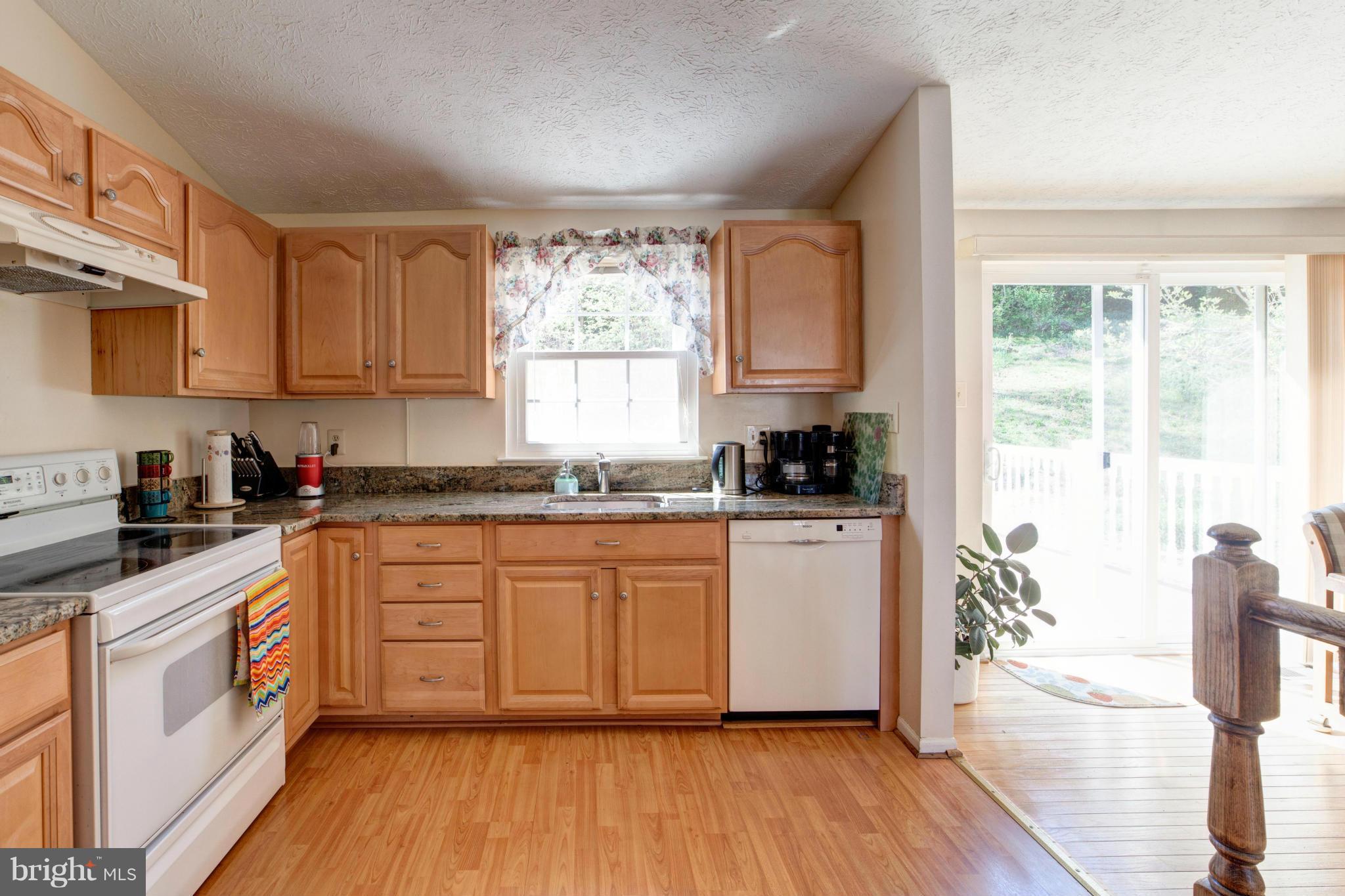 3116 Beethoven Way Silver Spring, MD 20904 - Photo 12 of 30 a kitchen with stainless steel appliances a white cabinets and wooden floor