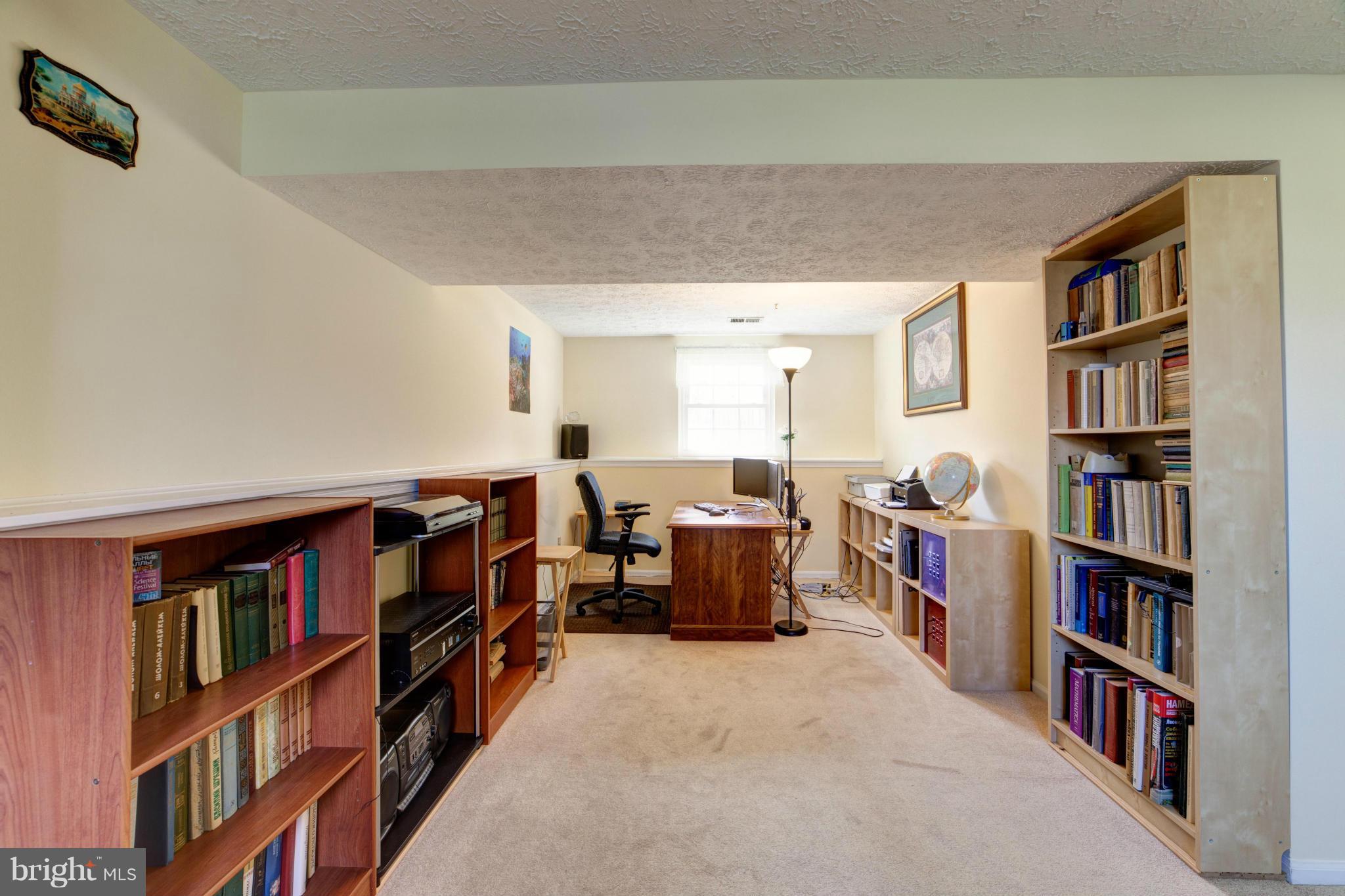 3116 Beethoven Way Silver Spring, MD 20904 - Photo 18 of 30 a living room with a book shelf and a book shelf
