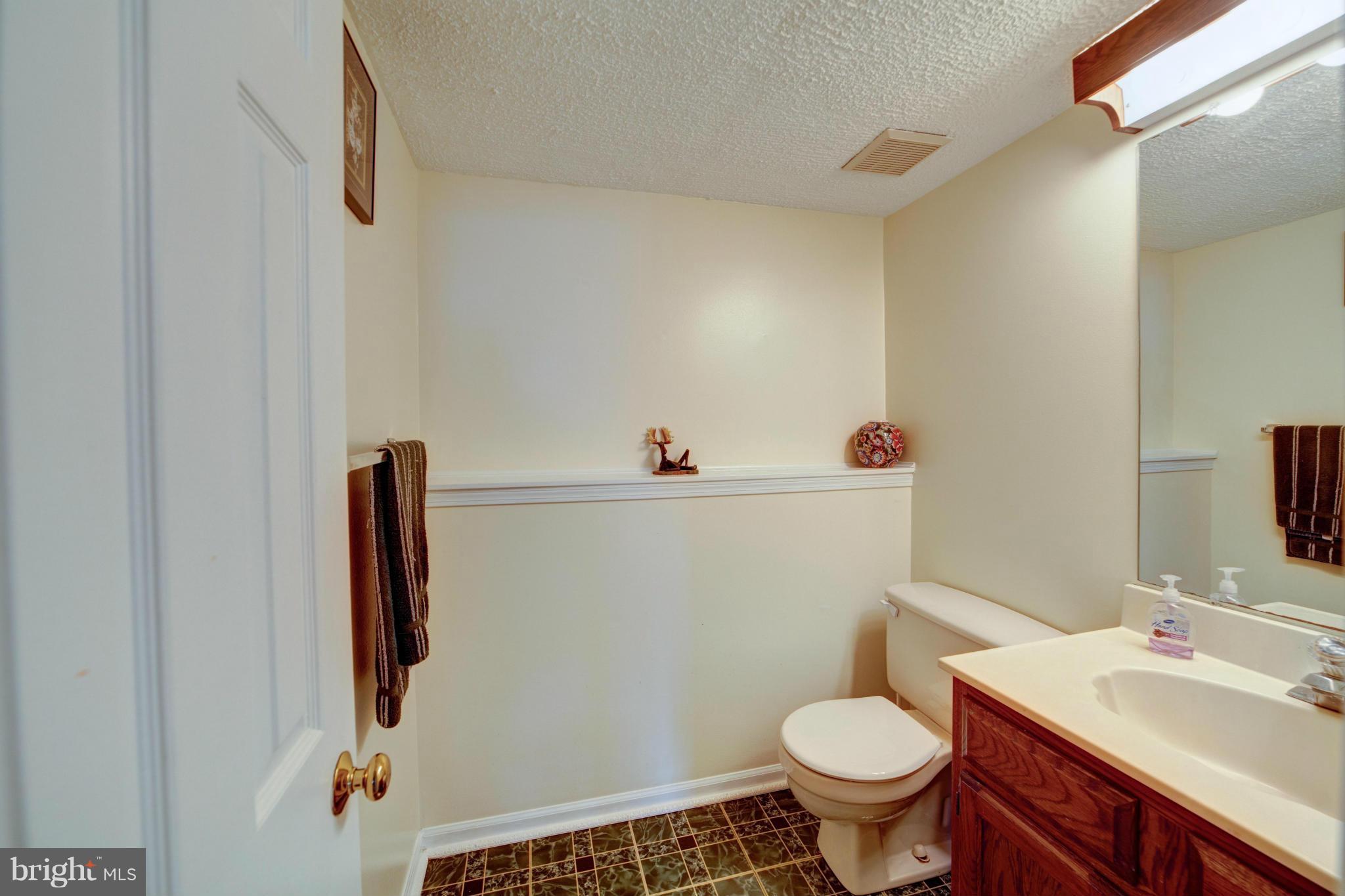 3116 Beethoven Way Silver Spring, MD 20904 - Photo 20 of 30 a bathroom with a sink toilet and a mirror