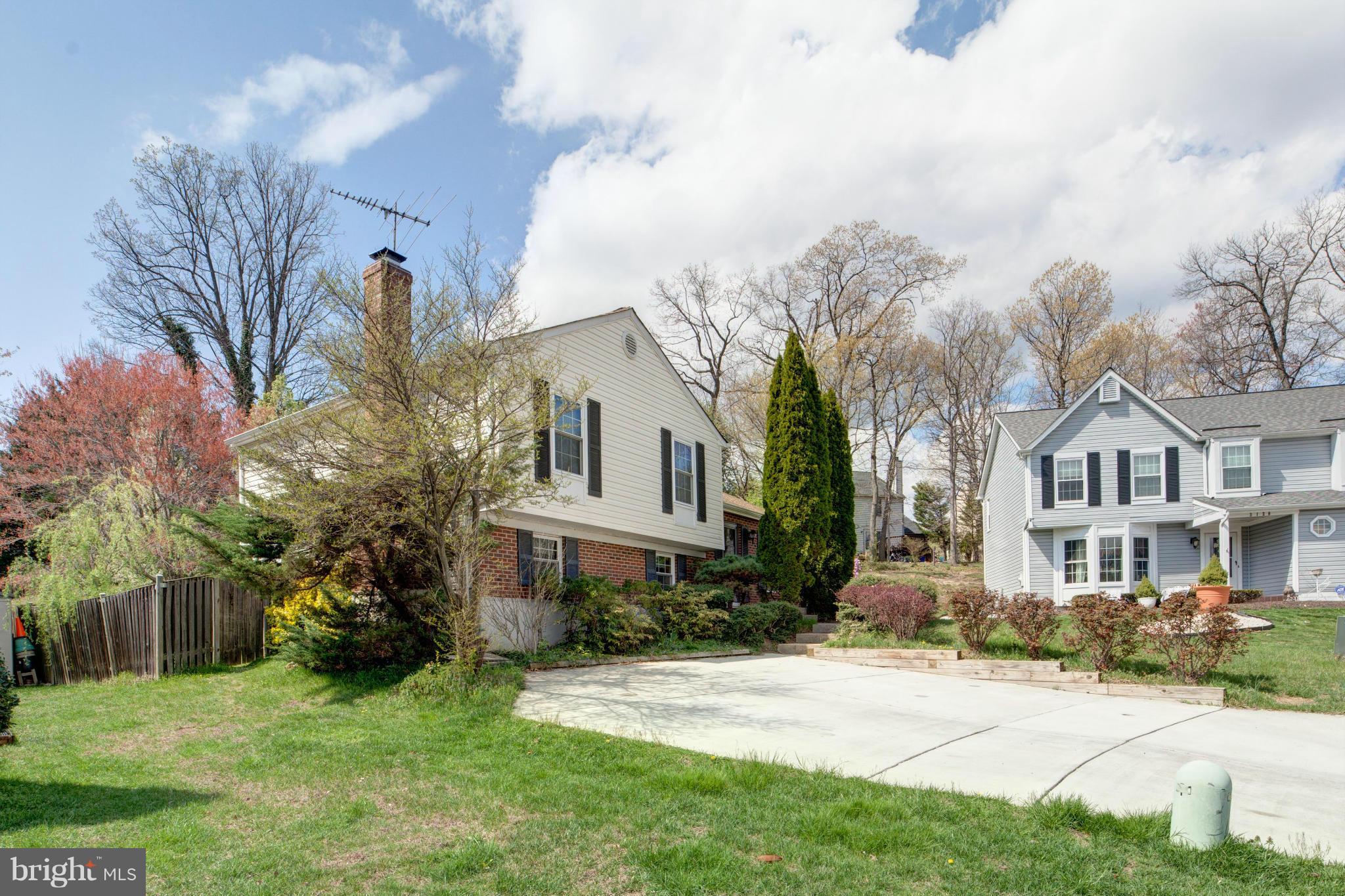 3116 Beethoven Way Silver Spring, MD 20904 - Photo 3 of 30 a view of a white house next to a yard with big trees